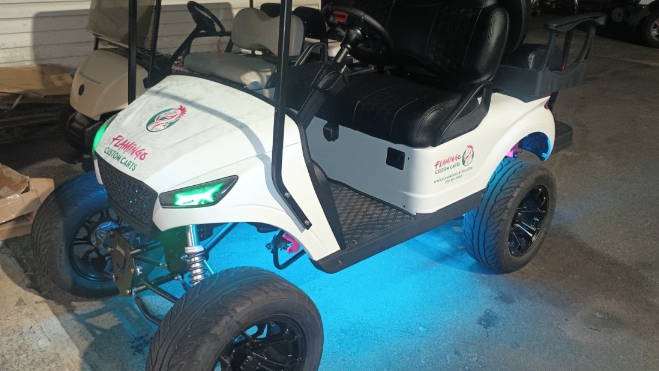 Customized golf cart with LED lights and aftermarket wheels from Flamingo Custom Carts in Atlanta.