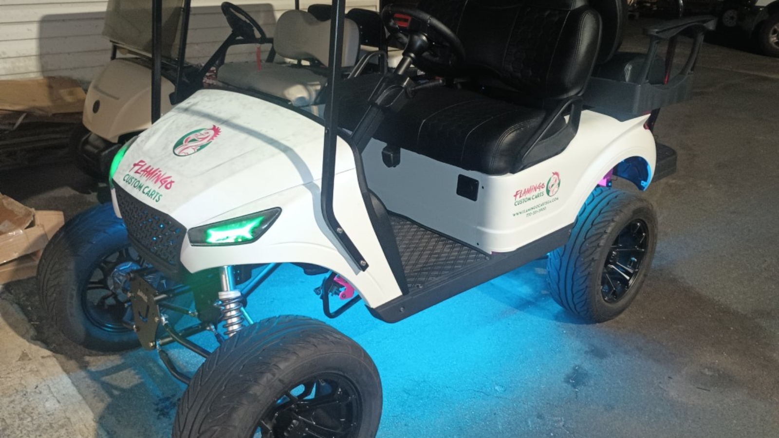 Customized golf cart with LED lights and aftermarket wheels from Flamingo Custom Carts in Atlanta.