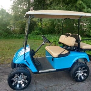 Customized blue golf cart with premium wheels and accessories by Flamingo Custom Carts.
