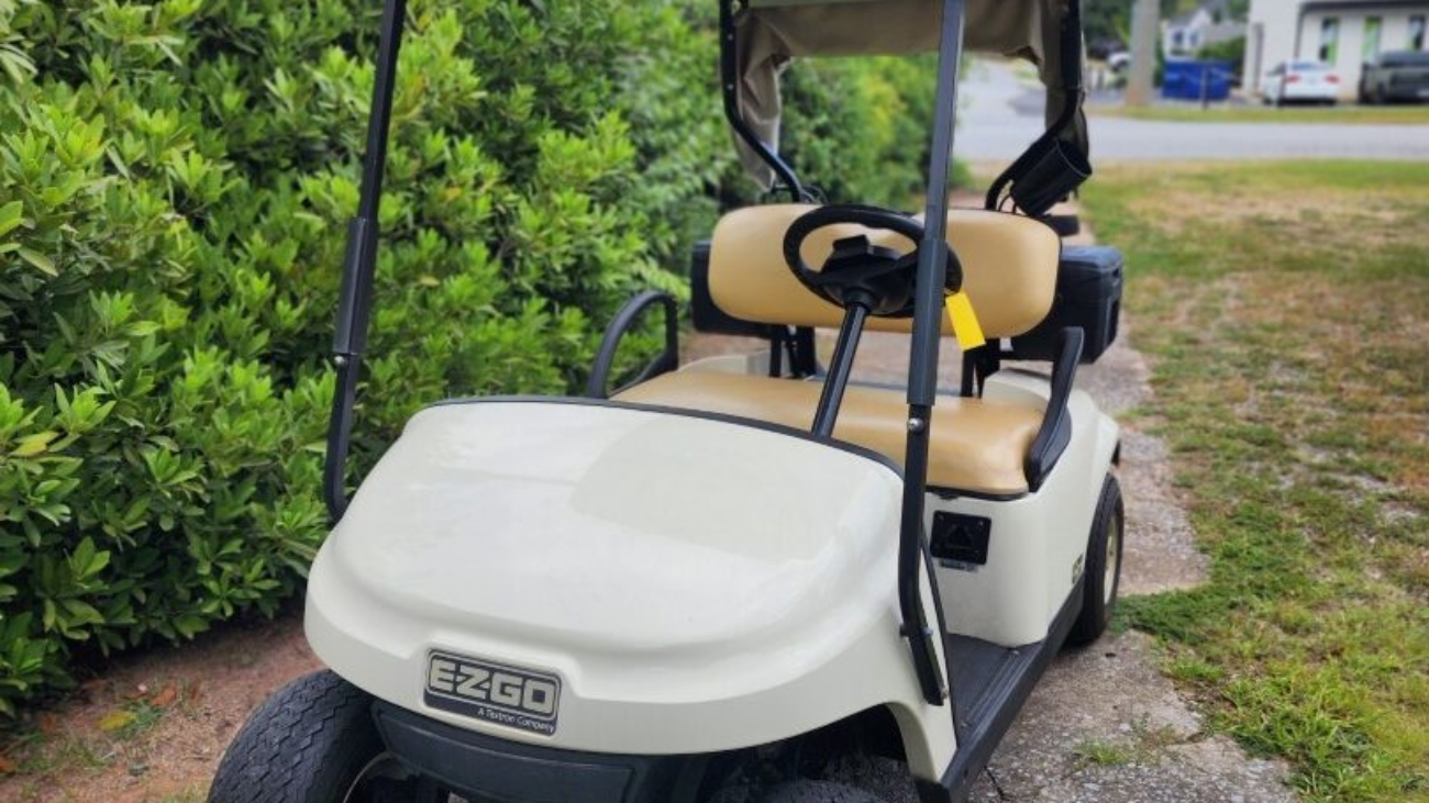 White 2019 EZGO TXT ELiTE lithium golf cart with windshield and cargo box