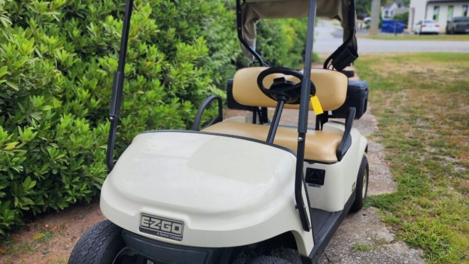 White 2019 EZGO TXT ELiTE lithium golf cart with windshield and cargo box