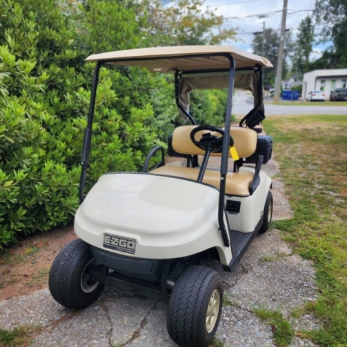 White 2019 EZGO TXT ELiTE lithium golf cart with windshield and cargo box