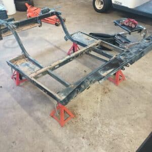 Custom golf cart frame undergoing transformation and customization.