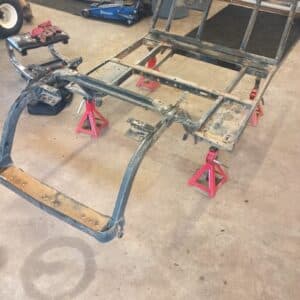 Custom golf cart frame undergoing transformation and customization.