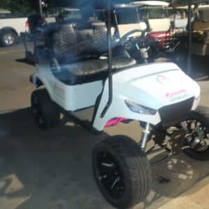 Customized white golf cart with pink accents and aftermarket wheels, showcasing Flamingo Custom Carts transformation.