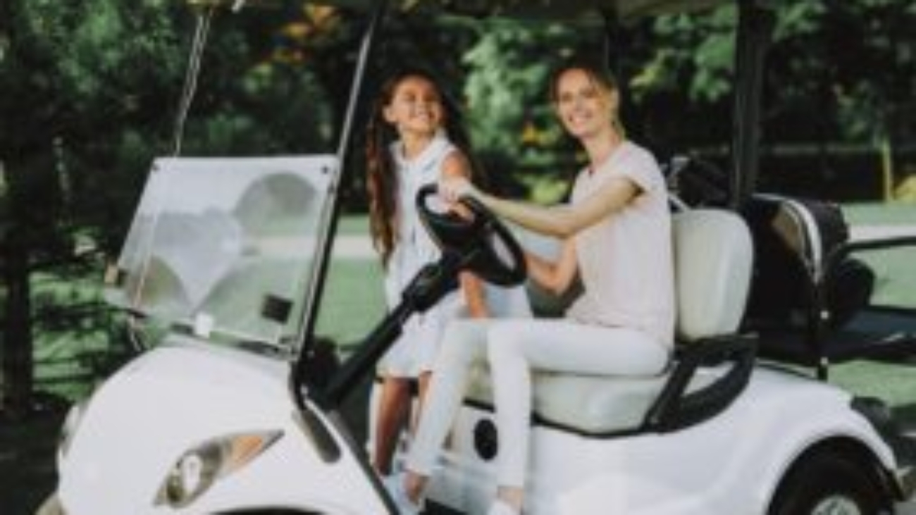 Woman and child riding in customized white golf cart