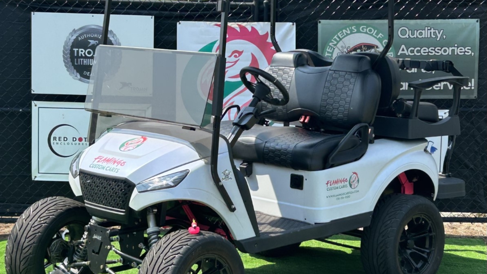 Custom 4-passenger golf cart with white exterior, black and red accents, and Flamingo Carts branding.
